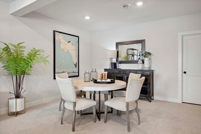 dining area featuring recessed lighting, baseboards, and light colored carpet