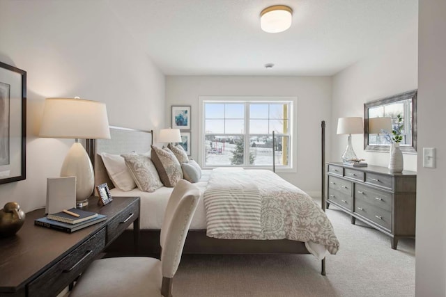 bedroom featuring light colored carpet and multiple windows
