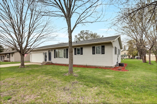 view of front of home with central air condition unit, an attached garage, concrete driveway, and a front lawn