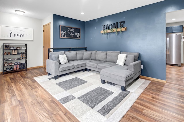 living room with baseboards, recessed lighting, and wood finished floors