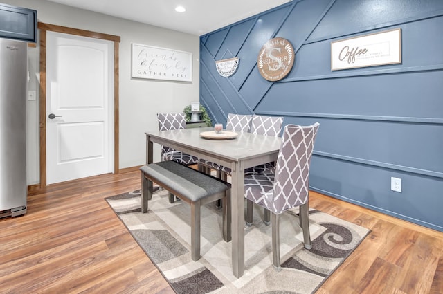 dining area with recessed lighting and wood finished floors