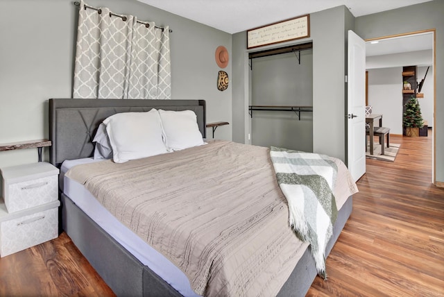 bedroom with a closet and wood finished floors