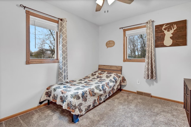 bedroom with visible vents, carpet floors, and multiple windows