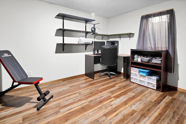 office area with baseboards and wood finished floors