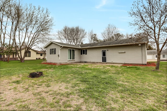back of house featuring a patio, an outdoor fire pit, and a yard