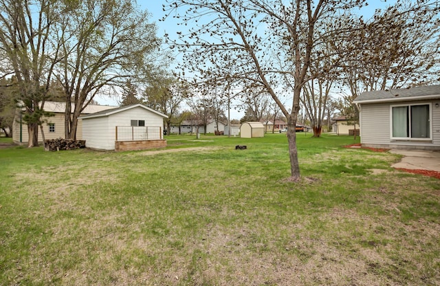 view of yard featuring a shed and an outbuilding