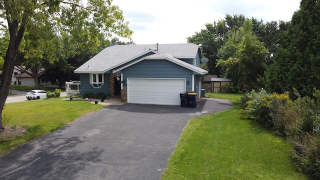 5634 142nd St W, Apple Valley, MN 55124 - view of front of property with a garage, driveway, a front lawn, and roof with shingles