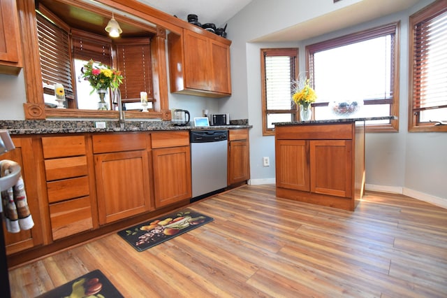 5634 142nd St W, Apple Valley, MN 55124 - kitchen with dishwasher, brown cabinetry, light wood finished floors, and dark stone countertops