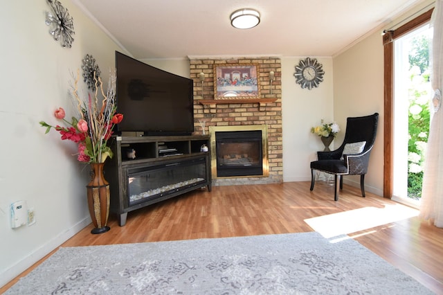 5634 142nd St W, Apple Valley, MN 55124 - living area with crown molding, wood finished floors, baseboards, and a brick fireplace