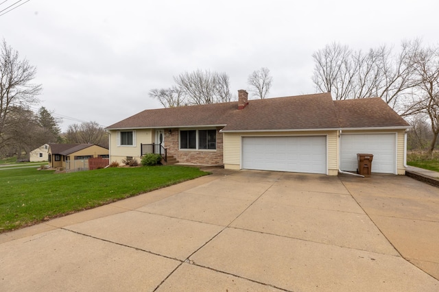 ranch-style house featuring a front yard, roof with shingles, a chimney, an attached garage, and driveway