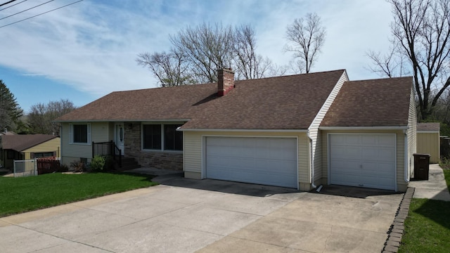 view of front of house with a chimney, roof with shingles, a garage, a front lawn, and concrete driveway
