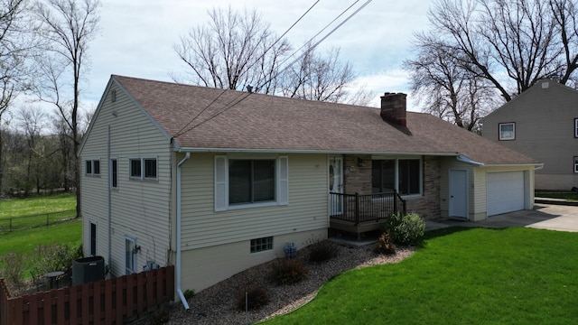 ranch-style house with roof with shingles, an attached garage, a front lawn, a chimney, and driveway