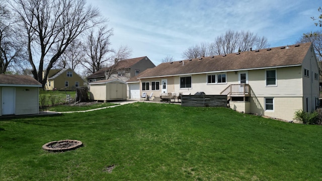 back of house with an outbuilding, a yard, a patio area, and a shed