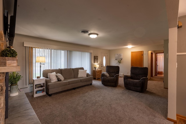 carpeted living room featuring a stone fireplace, visible vents, plenty of natural light, and a baseboard radiator