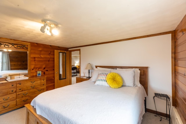 bedroom with wooden walls and light carpet