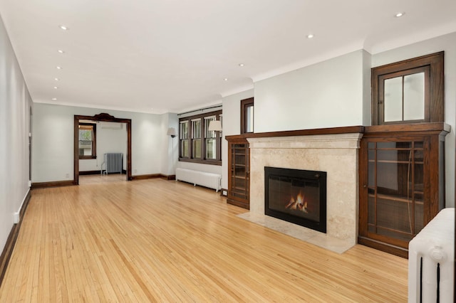 1287 Avon St N, Saint Paul, MN 55117 - unfurnished living room with radiator, wood finished floors, and recessed lighting