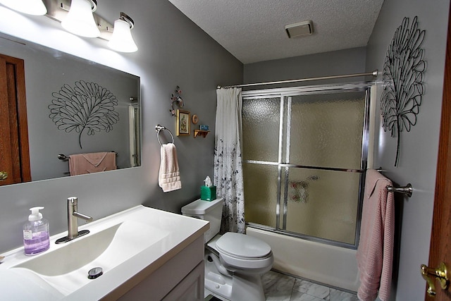 222 Sargent Dr Unit 102, Red Wing, MN 55066 - full bathroom with vanity, toilet, a textured ceiling, marble finish floor, and bath / shower combo with glass door