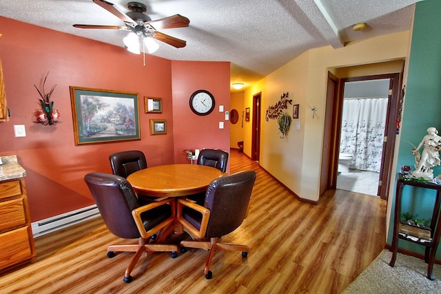222 Sargent Dr Unit 102, Red Wing, MN 55066 - dining room with a ceiling fan, a textured ceiling, baseboard heating, and light wood finished floors