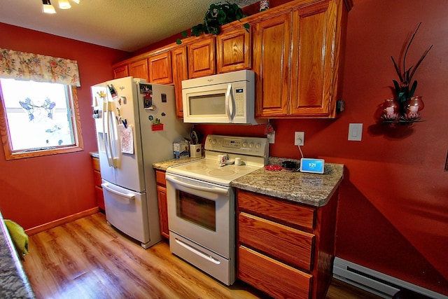 222 Sargent Dr Unit 102, Red Wing, MN 55066 - kitchen with white appliances, a textured ceiling, a baseboard heating unit, brown cabinets, and light wood-style flooring