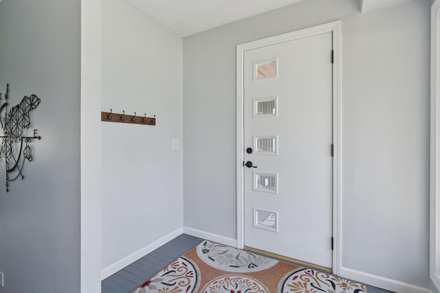 doorway to outside featuring baseboards