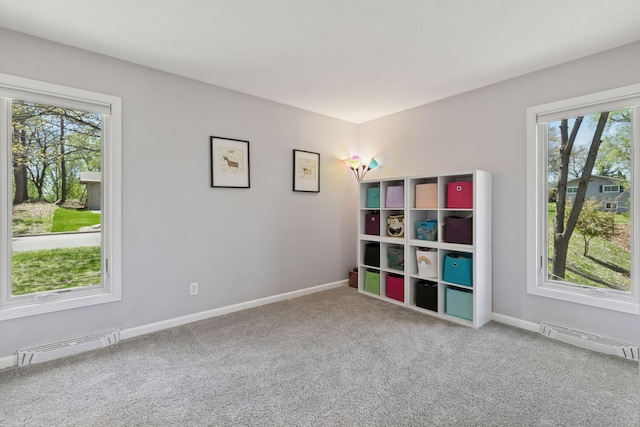recreation room featuring carpet, visible vents, and a healthy amount of sunlight