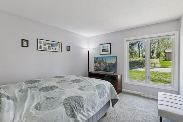 bedroom featuring light colored carpet, baseboards, and visible vents