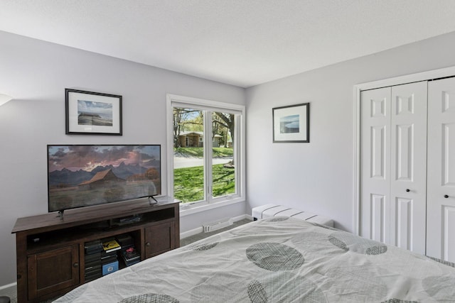 bedroom featuring a closet and baseboards