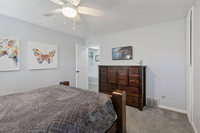 carpeted bedroom featuring baseboards, visible vents, and a ceiling fan