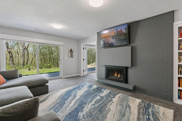 carpeted living area with a fireplace, a textured ceiling, and baseboards
