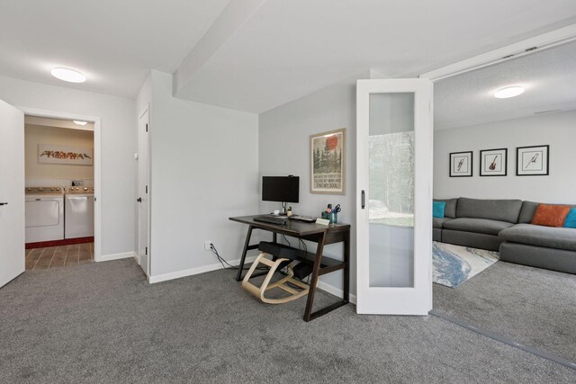 carpeted office space with washer and clothes dryer and baseboards