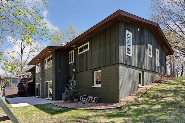 back of house featuring a yard, a patio area, and central AC unit
