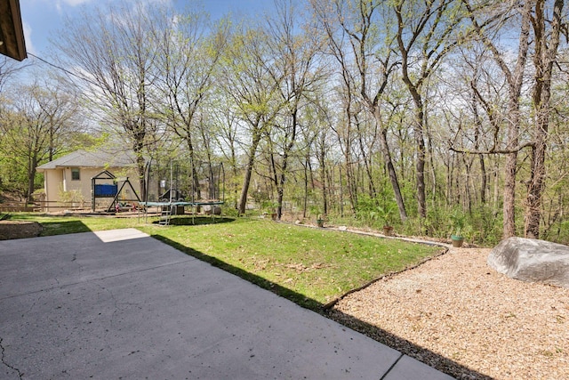view of yard with a patio area and a trampoline