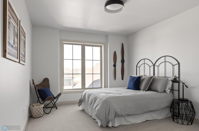carpeted bedroom featuring baseboards
