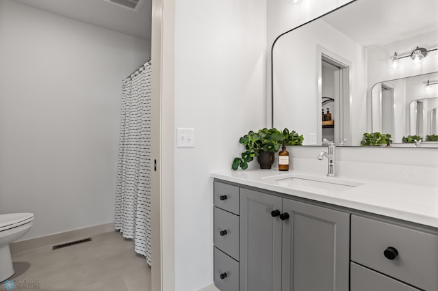 bathroom featuring visible vents, toilet, and vanity