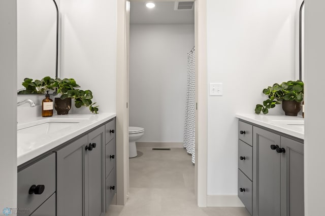 full bath featuring toilet, baseboards, visible vents, and vanity