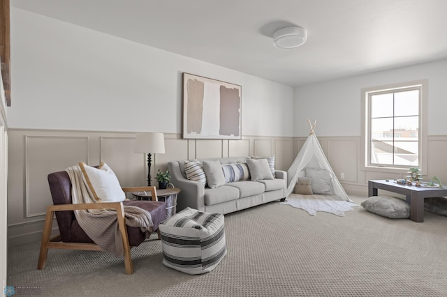 interior space featuring wainscoting, a decorative wall, and carpet flooring