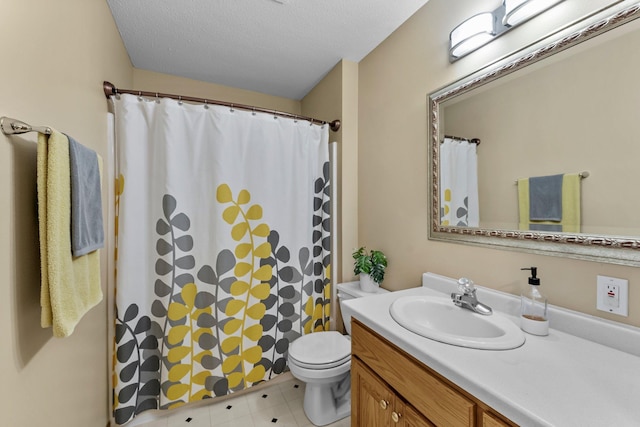 bathroom featuring vanity, toilet, a shower with shower curtain, and a textured ceiling