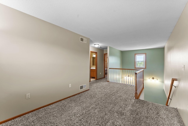 carpeted spare room with baseboards