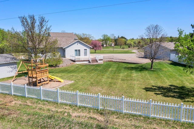 view of yard featuring a playground and a wooden deck