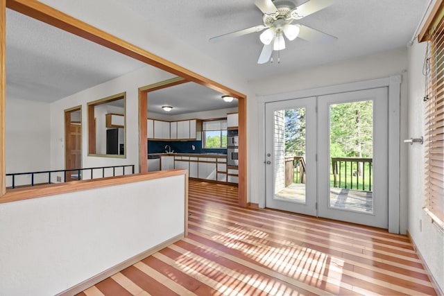 1791 Lois Dr, Shoreview, MN 55126 - doorway to outside featuring wood finished floors, a sink, a ceiling fan, and a textured ceiling
