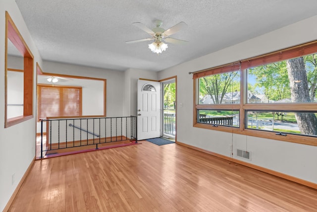 1791 Lois Dr, Shoreview, MN 55126 - unfurnished room featuring wood finished floors, a textured ceiling, ceiling fan, and baseboards