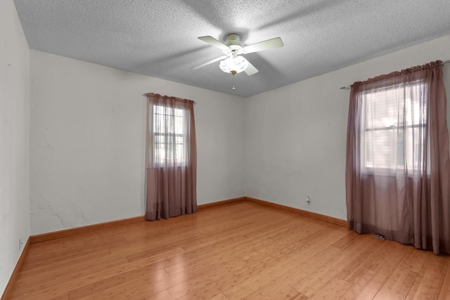 1791 Lois Dr, Shoreview, MN 55126 - unfurnished room with light wood finished floors, ceiling fan, a textured ceiling, and baseboards