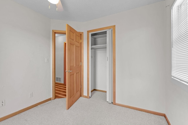 1791 Lois Dr, Shoreview, MN 55126 - unfurnished bedroom featuring light carpet, baseboards, a closet, and a ceiling fan
