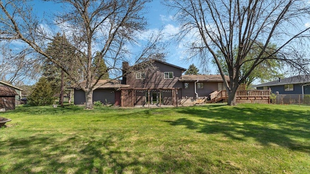 rear view of property with a wooden deck and a chimney