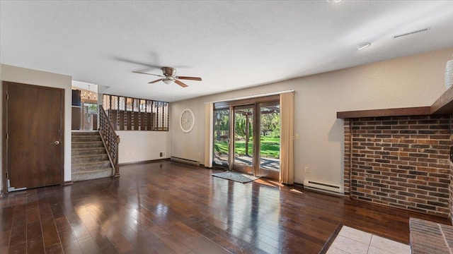 unfurnished living room with a baseboard radiator, a ceiling fan, hardwood / wood-style floors, and stairway