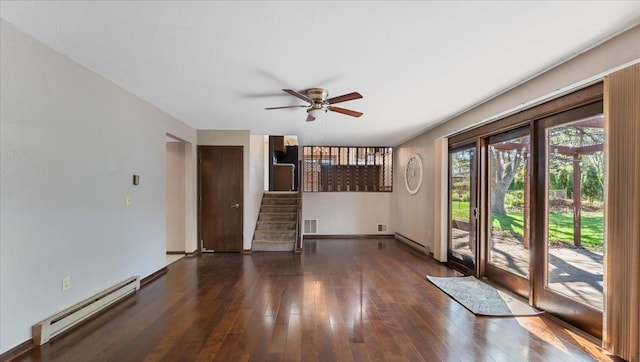 unfurnished living room featuring a baseboard heating unit, stairs, a ceiling fan, and hardwood / wood-style floors