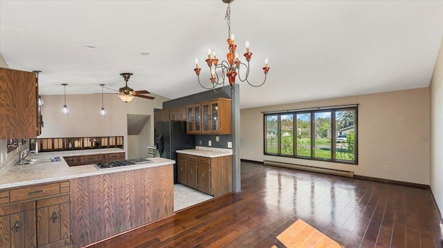 kitchen featuring a baseboard radiator, stovetop with downdraft, ceiling fan, a peninsula, and glass insert cabinets