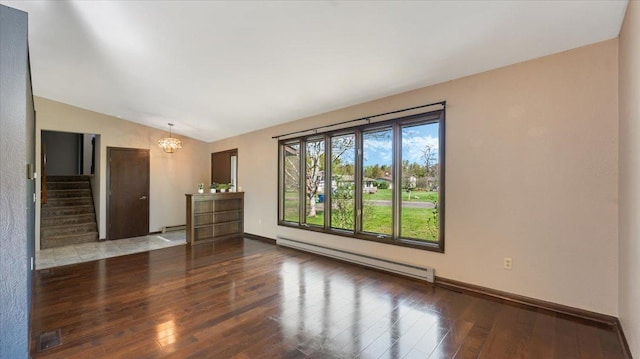 unfurnished living room with a baseboard radiator, a chandelier, wood-type flooring, lofted ceiling, and stairs