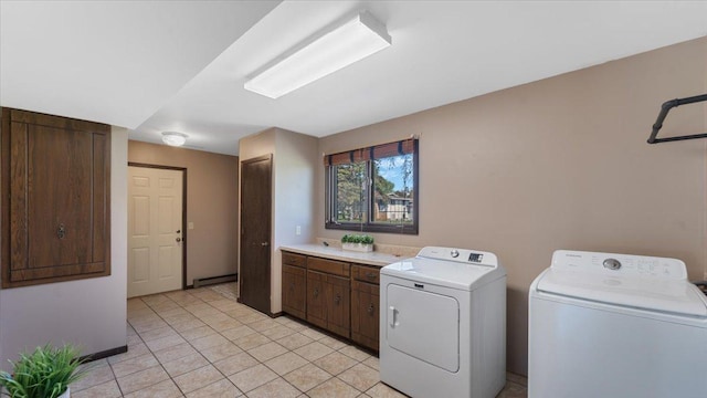 laundry area with separate washer and dryer, a baseboard heating unit, light tile patterned flooring, cabinet space, and baseboards
