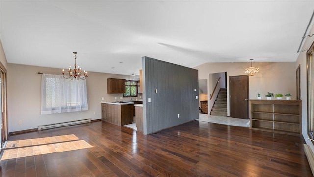kitchen with a baseboard radiator, a chandelier, light countertops, dark wood-style flooring, and lofted ceiling